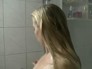 Young woman taking shower in the bathroom